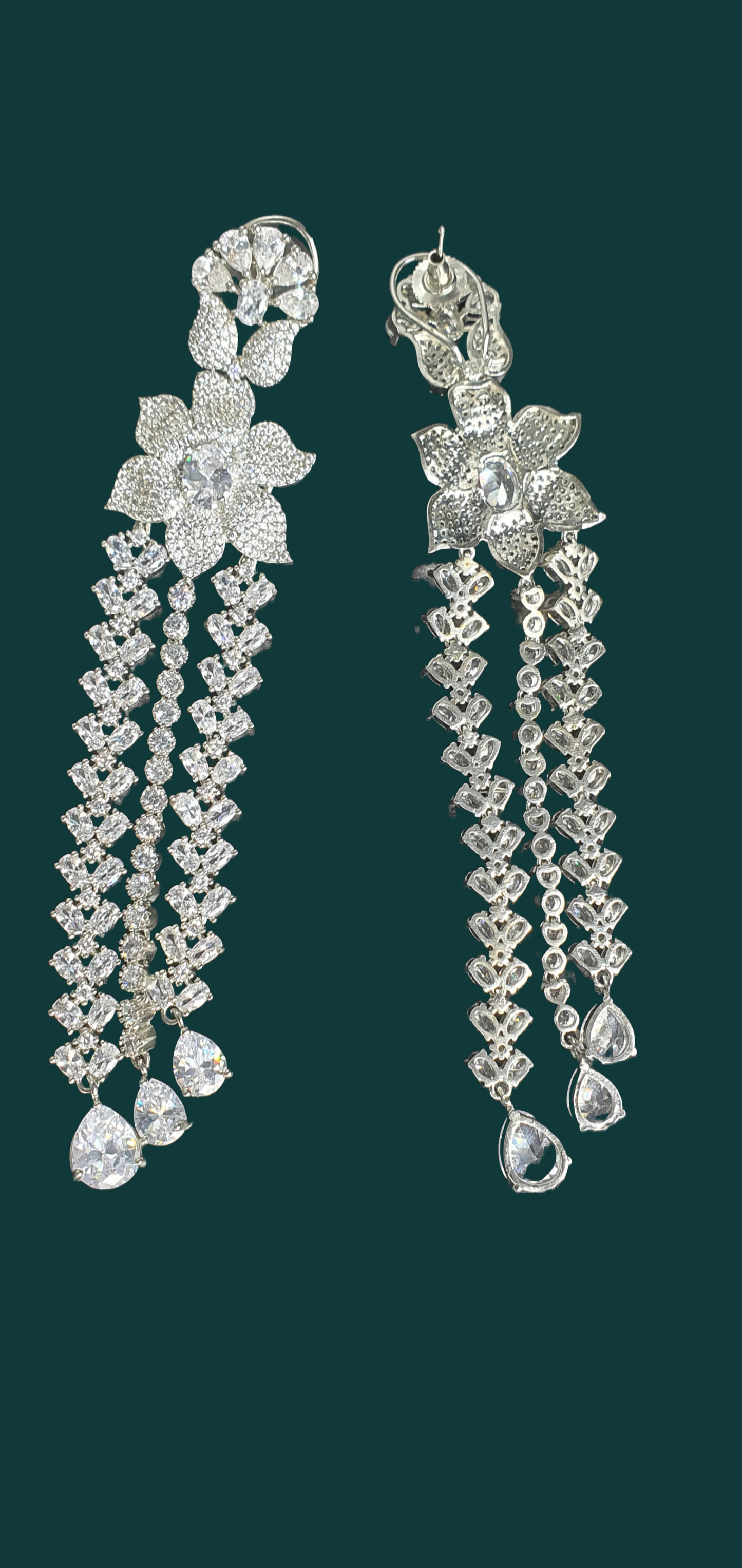 Shine bright at your next formal event with Raani's long statement dangler earrings for women. Crafted for elegance, these stunning earrings feature cascading platinum-finish titanium steel chains that ooze luxury and sophistication. Sparkling American diamonds adorn each chain, capturing and reflecting light with every movement. Lightweight and comfortable, these long statement dangler earrings for women allow you to enjoy your evening without any hassle.