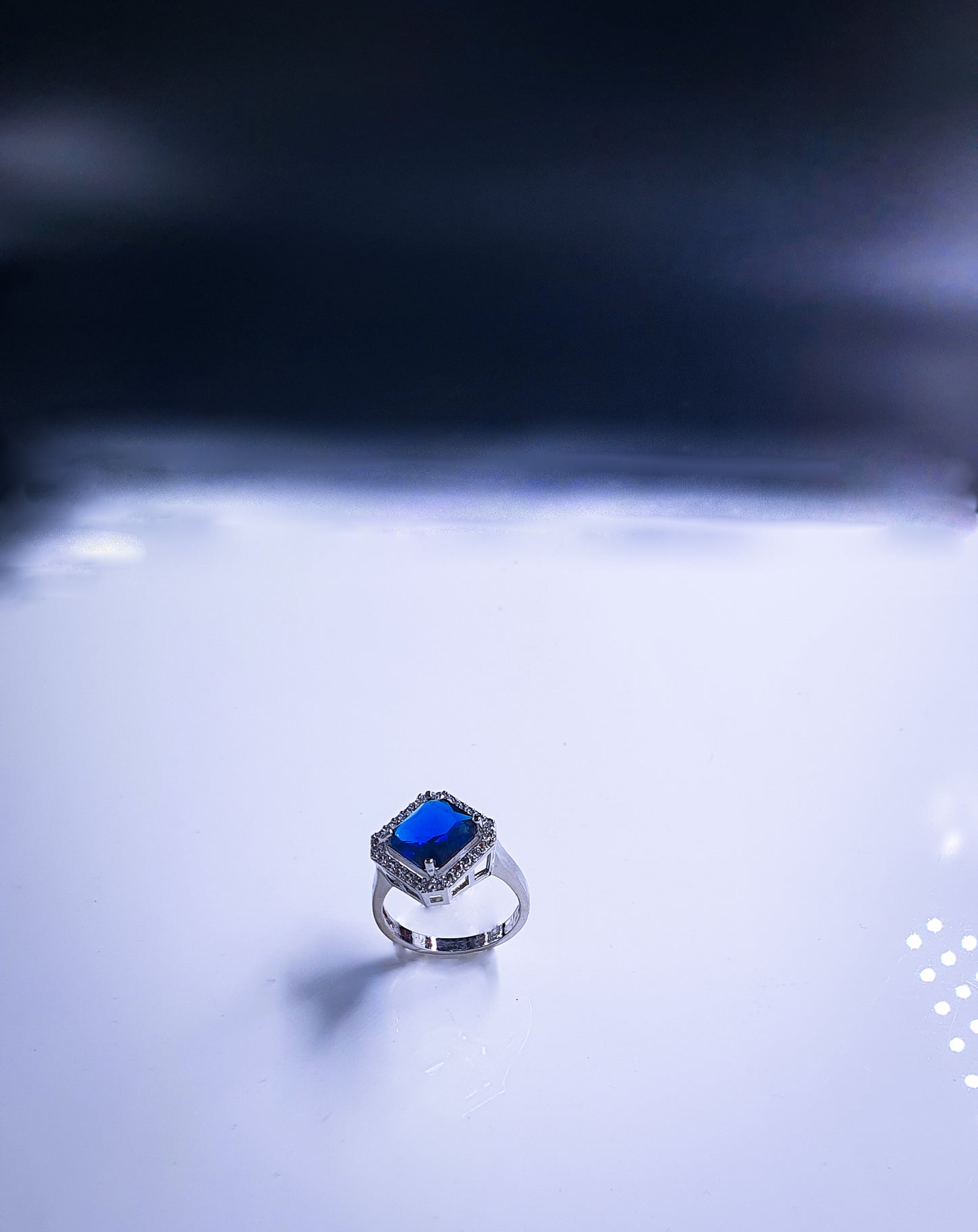 Introducing Raani's Radiant Blue Glass Stone Ring, a royal blue statement ring for women that embodies elegance and sophistication. This stunning piece features a captivating blue glass stone at its centre, surrounded by shimmering American diamonds. Crafted with meticulous attention to detail, it exudes timeless beauty.