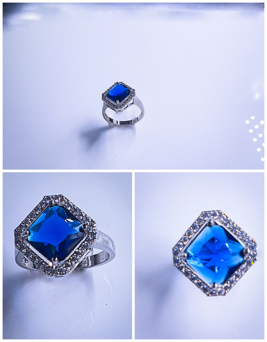 Introducing Raani's Radiant Blue Glass Stone Ring, a royal blue statement ring for women that embodies elegance and sophistication. This stunning piece features a captivating blue glass stone at its centre, surrounded by shimmering American diamonds. Crafted with meticulous attention to detail, it exudes timeless beauty.