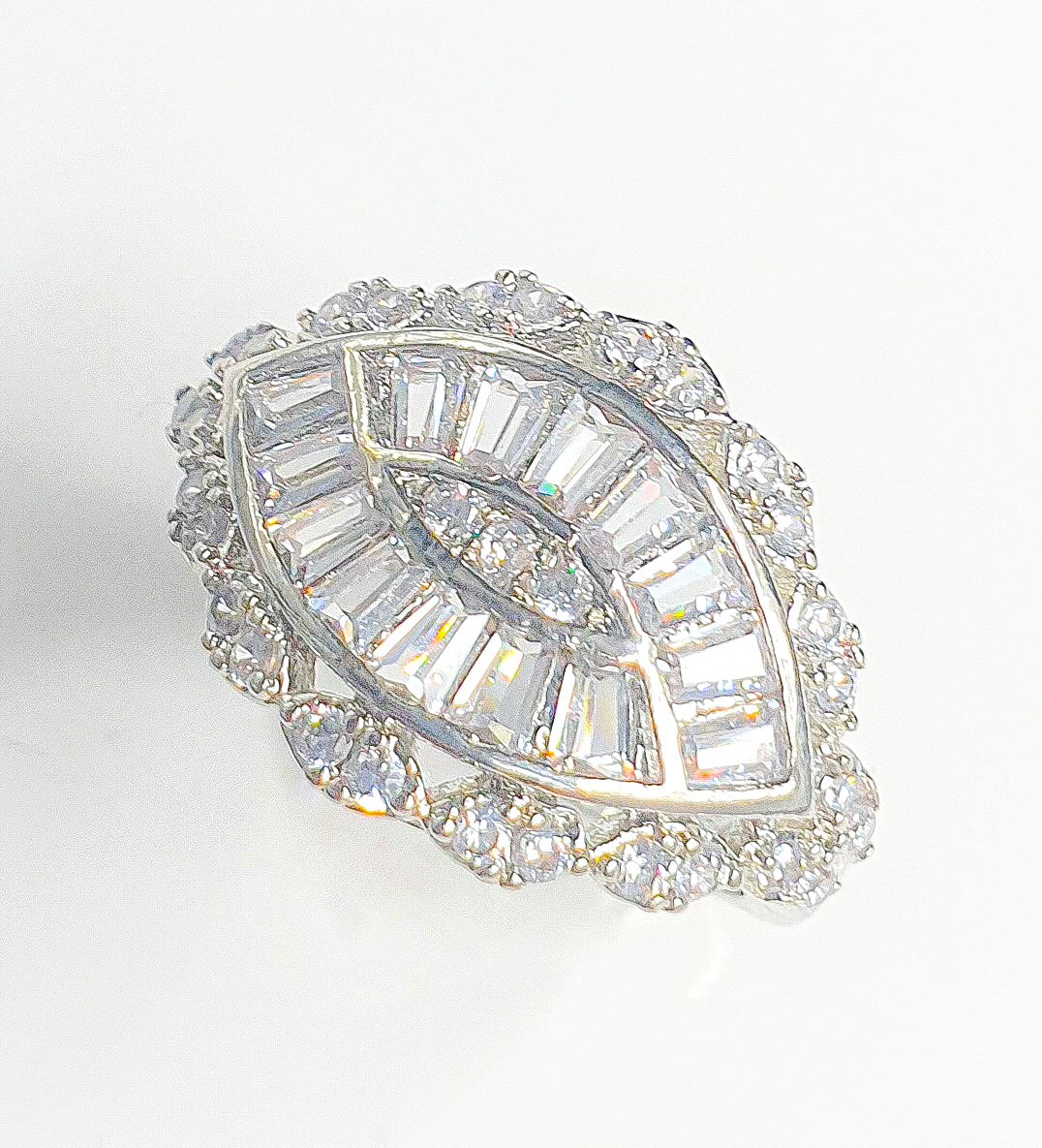 Elevate your style with Raani's Deco Radiance Ring, an art deco style statement ring that exudes boldness and sophistication. This stunning ring features dazzling American diamonds, capturing the essence of vintage glamour. Designed to make a statement, the intricate art deco patterns offer a timeless elegance that enhances any outfit.