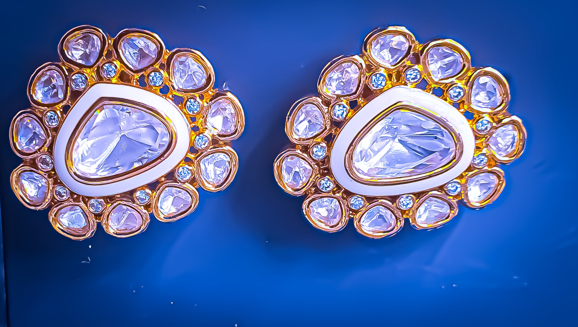 Enhance your style with Raani's Chandini Studs, featuring sophisticated Indian Kundan studs with American Diamonds. These exquisite pieces blend the brilliance of silver-foil Kundan and American diamonds in a Deco-inspired design. Their versatile elegance makes them perfect for any occasion.