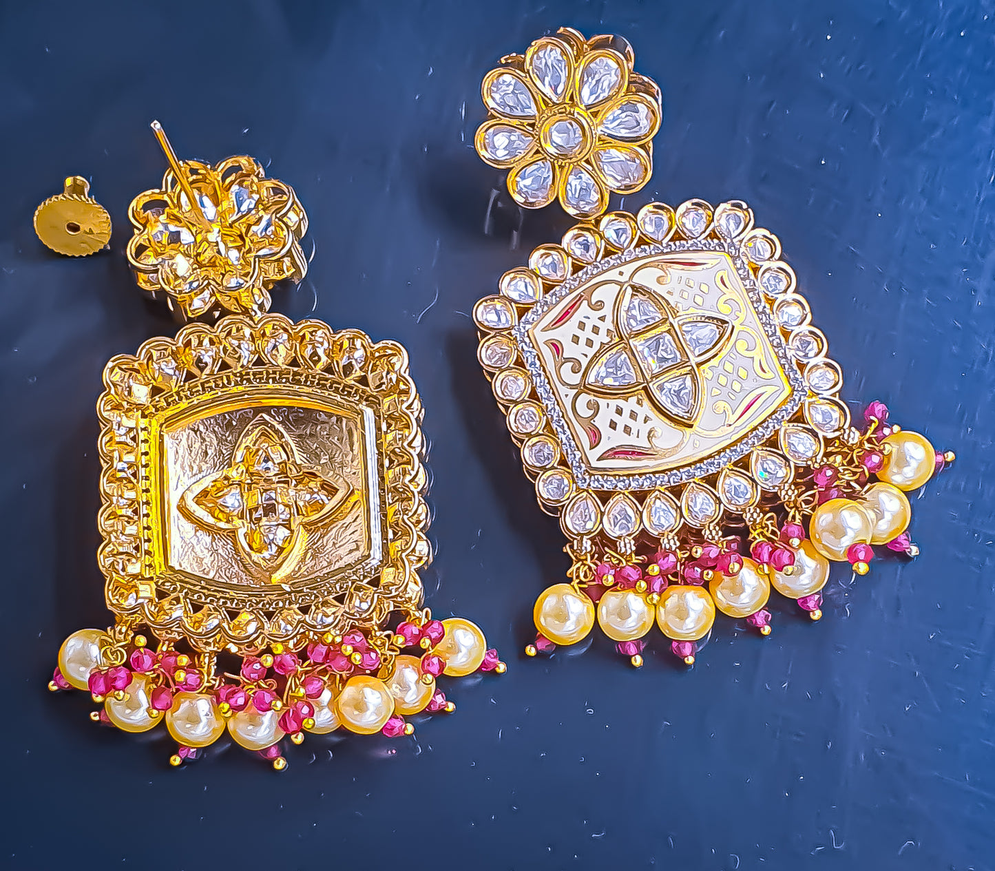 Introducing Raani's Ethnic Indian designer earrings with Kundan, pearls and cubic zirconia that are perfect for any special occasion. Aptly called Raani's Maya Earrings, these elegant earrings feature a gold-plated square design with intricate detailing, showcasing the beauty of traditional craftsmanship.