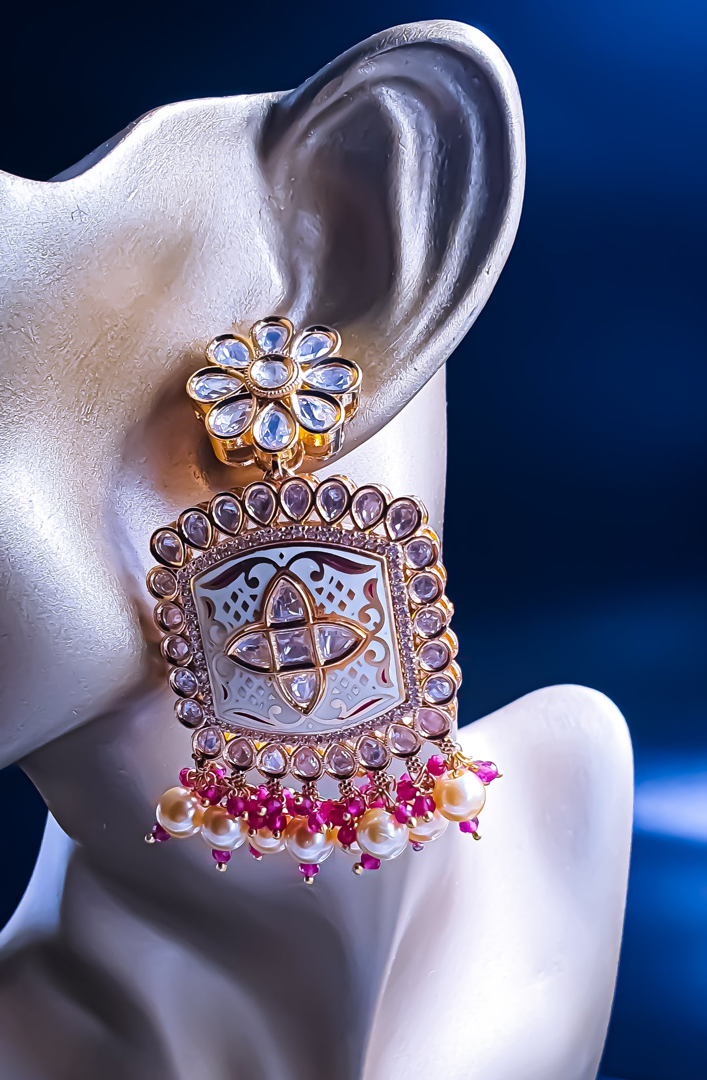 Introducing Raani's Ethnic Indian designer earrings with Kundan, pearls and cubic zirconia that are perfect for any special occasion. Aptly called Raani's Maya Earrings, these elegant earrings feature a gold-plated square design with intricate detailing, showcasing the beauty of traditional craftsmanship.