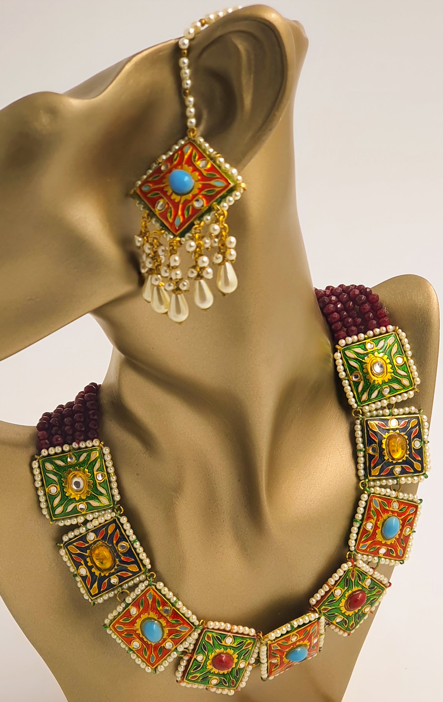 Shine in this exquisite colourful Indian ethnic light-weight necklace set, hand-crafted and studded with multi-coloured semi-precious stones. This beautiful set features high-quality gold plating and a light-weight design, making it perfect for pairing with all Indian ethnic dresses, especially designer lehenga cholis.