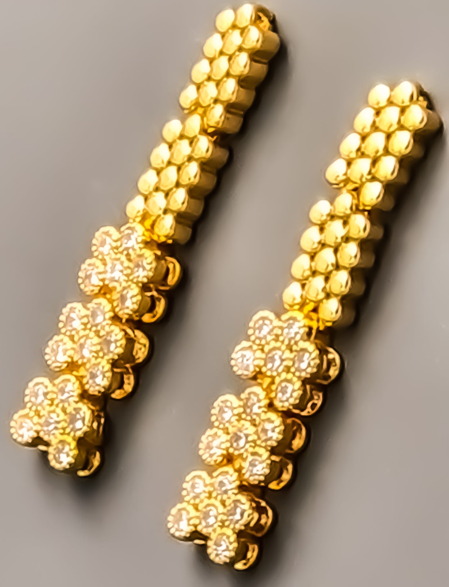 Introducing Raani's Golden Starlight Necklace Set, a rich gold plated designer necklace set that radiates enduring elegance. Crafted with high-quality gold plating and adorned with shimmering American Diamonds, this set dazzles with a celestial sparkle. Despite being artificial, the gold plating ensures lasting shine with proper care.