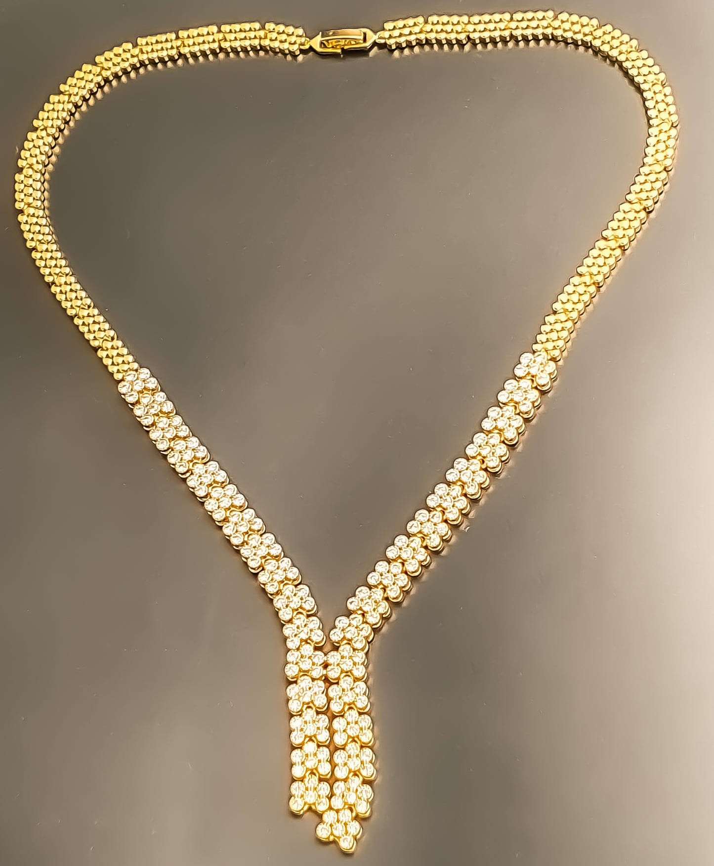 Introducing Raani's Golden Starlight Necklace Set, a rich gold plated designer necklace set that radiates enduring elegance. Crafted with high-quality gold plating and adorned with shimmering American Diamonds, this set dazzles with a celestial sparkle. Despite being artificial, the gold plating ensures lasting shine with proper care.