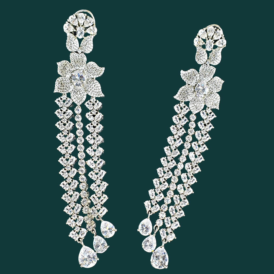 Shine bright at your next formal event with Raani's long statement dangler earrings for women. Crafted for elegance, these stunning earrings feature cascading platinum-finish titanium steel chains that ooze luxury and sophistication. Sparkling American diamonds adorn each chain, capturing and reflecting light with every movement.  Lightweight and comfortable, these long statement dangler earrings for women allow you to enjoy your evening without any hassle. 