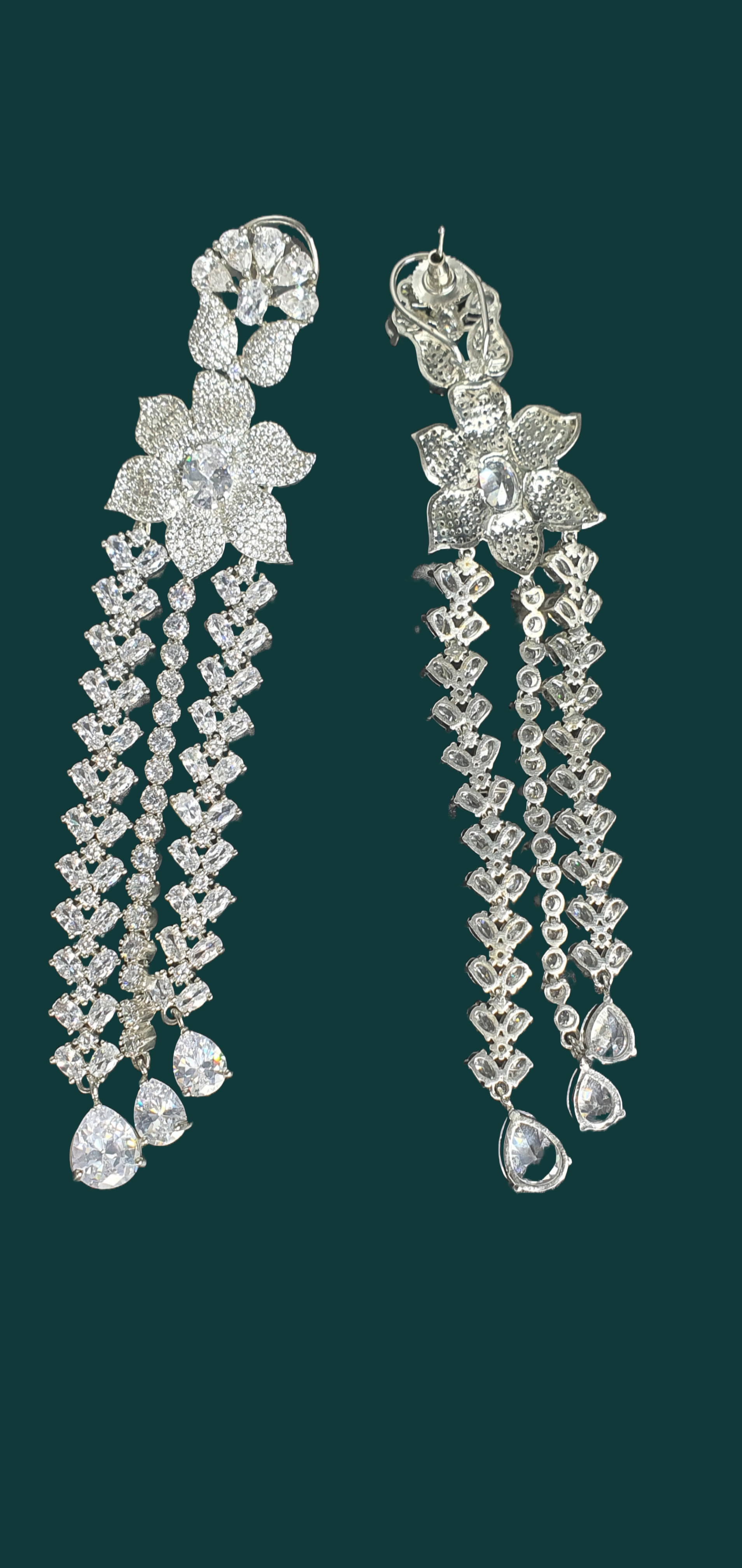 Shine bright at your next formal event with Raani's long statement dangler earrings for women. Crafted for elegance, these stunning earrings feature cascading platinum-finish titanium steel chains that ooze luxury and sophistication. Sparkling American diamonds adorn each chain, capturing and reflecting light with every movement.  Lightweight and comfortable, these long statement dangler earrings for women allow you to enjoy your evening without any hassle. 